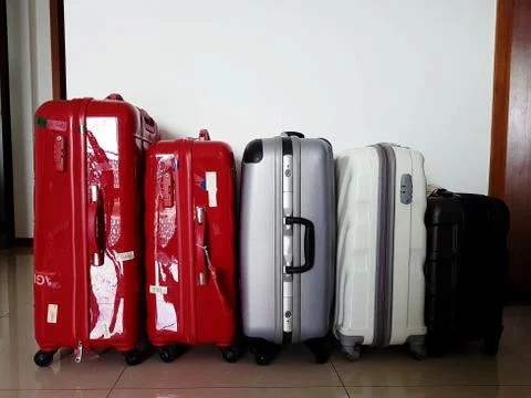 Different types, colors and sizes of trolley bag luggages in a row Stock Photos