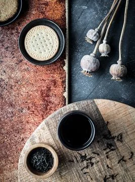 Different types of cookies and cup of coffee on grey and teracota background. Stock Photos