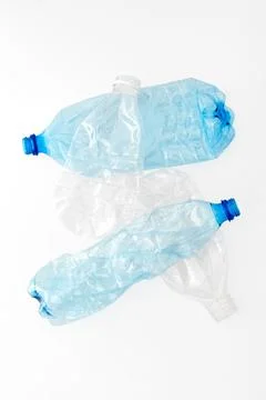 Different types of crushed plastic bottles on white background. Recyclable wa Stock Photos