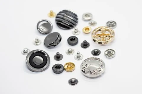 Different types of decorative buttons for use on bags, clothes, wallets. Meta Stock Photos