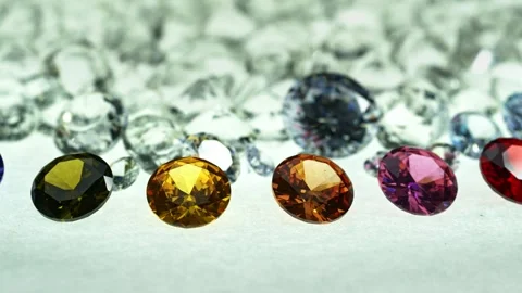 ..different types of diamonds are arranged in a row in front of a pile of whi Stock Footage 249261175