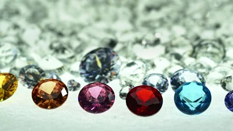 ..different types of diamonds are arranged in a row in front of a pile of whi Stock Footage 249261246