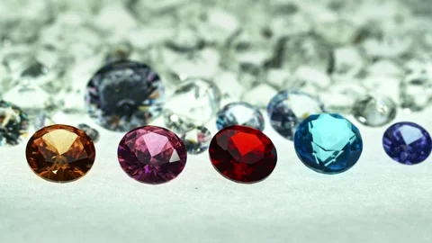 ..different types of diamonds are arranged in a row in front of a pile of whi Stock Footage 252433012