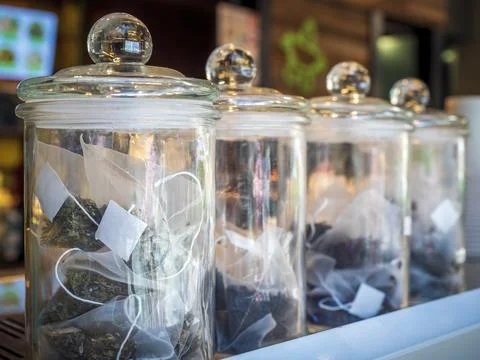 Different types of dried and crushed herbal tea leaves in individual bags Stock Photos