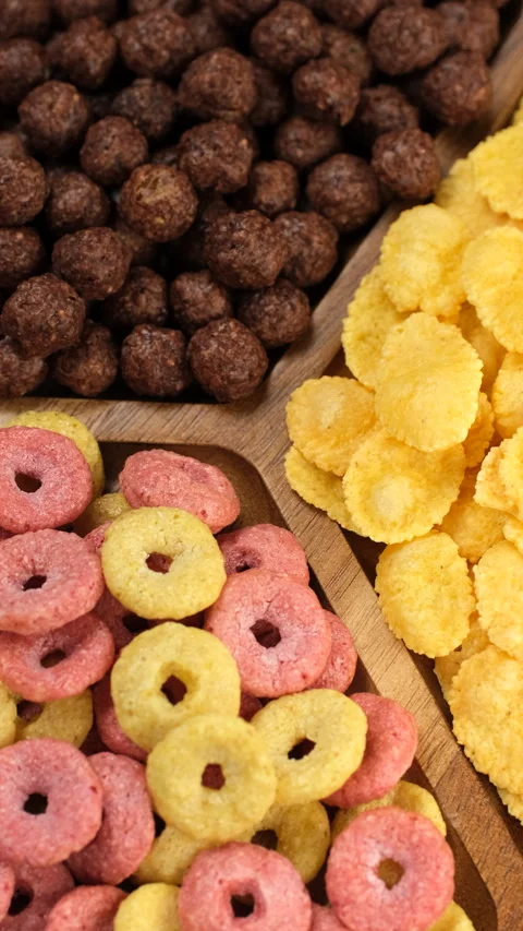 Different types of dry breakfast cereal in wooden plate, rotation Stock Footage 326197830