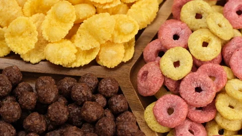 Different types of dry breakfast cereal in wooden plate, rotation Stock Footage 326197916