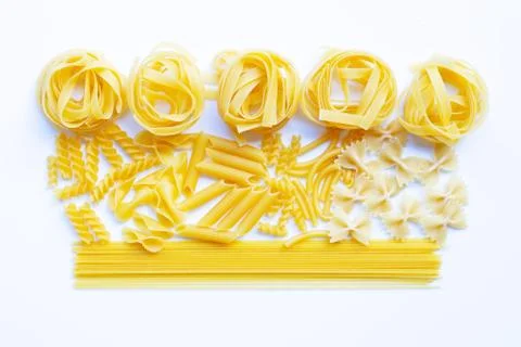 Different types of dry pasta on white. Stock Photos