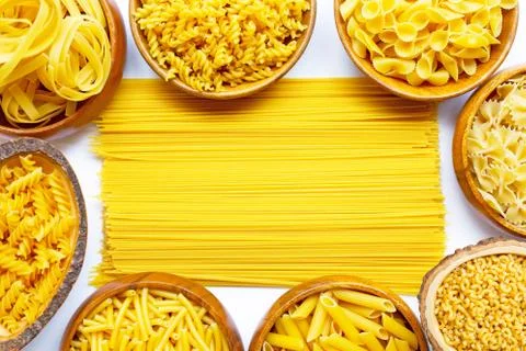 Different types of dry pasta on white. Stock Photos