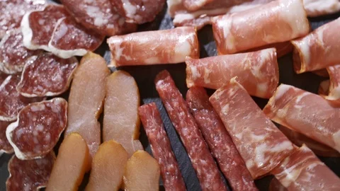 Different types of dry sausages on plate Stock Footage 116878663