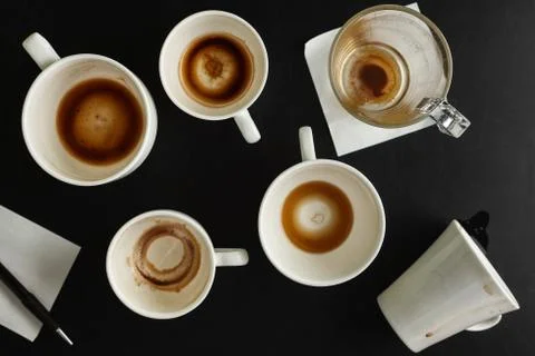 Different types of empty coffee cups on black table. Overhead view Stock Photos