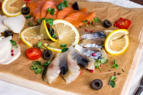 Different types of fish herring, salmon on wooden Board Stock Photos