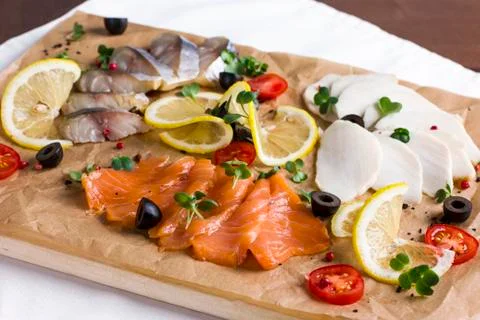Different types of fish herring, salmon on wooden Board Stock Photos