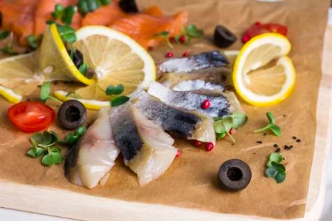 Different types of fish herring, salmon on wooden Board Stock Photos