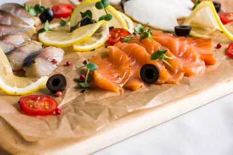 Different types of fish herring, salmon on wooden Board Stock Photos