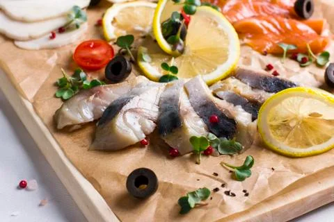 Different types of fish herring, salmon on wooden Board Stock Photos
