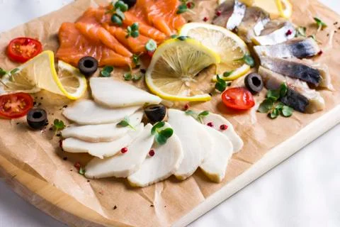 Different types of fish herring, salmon on wooden Board Stock Photos