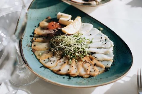 Different types of fish on a plate. Wedding table setting with food in restau Stock Photos