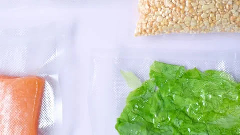Different types of food packed in vacuum bags on lilac background top view. Stock Footage 280450651