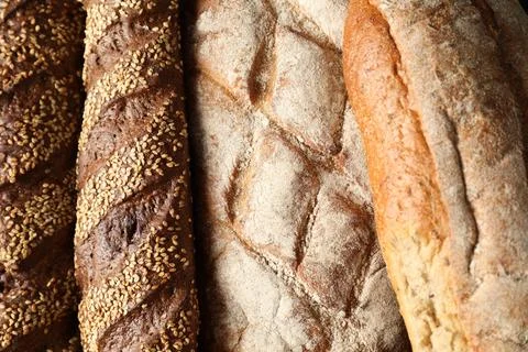 Different types of fresh bread as background, top view Stock Photos