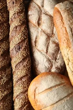 Different types of fresh bread as background, top view 스톡 사진