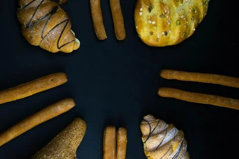 Different types of fresh bread with grain on a black rustic background. the b Stock Photos