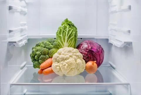 Different types of fresh cabbage, carrots and onions lie in the center of an Stock Photos