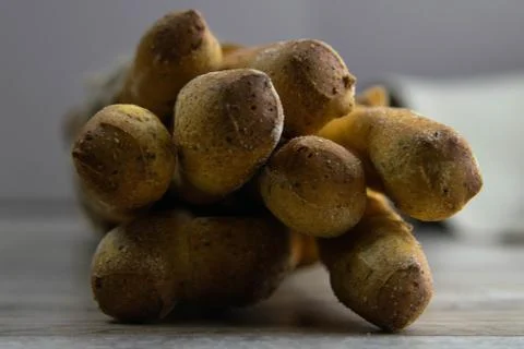 Different types of fresh spice bread sticks in a craft bag stand on a wooden  Stock Photos