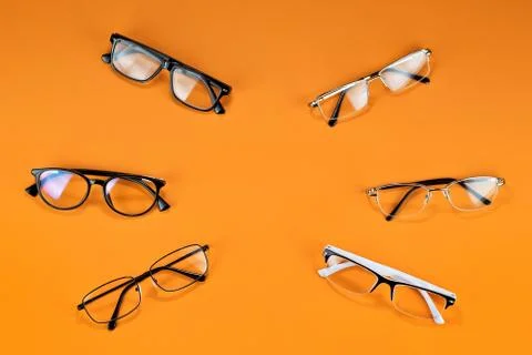 Different types of glasses on an orange background close up. Glasses with rec Stock Photos