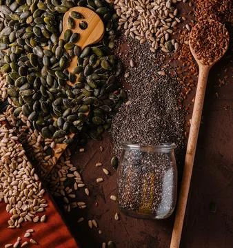 Different types of grains and seeds on shabby wooden Stock Photos