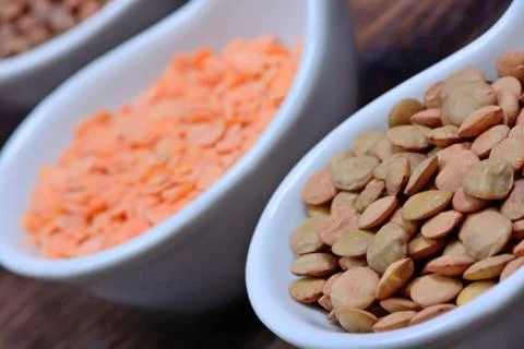 Different types of lentils in a ceramic spoons Stock Photos