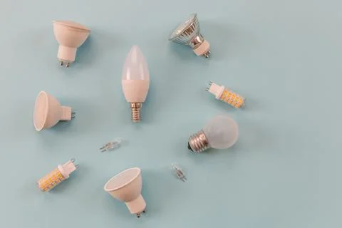 Different types of light bulbs on a blue background. background for text Stock Photos