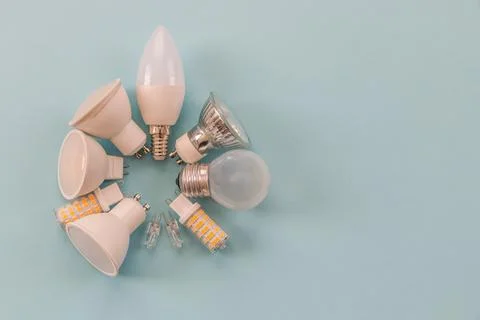 Different types of light bulbs on a blue background. background for text Stock Photos