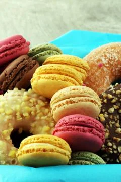 Different types of macaroons and donuts in a box Stock Photos