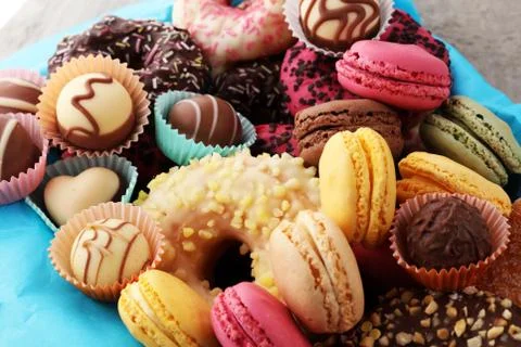 Different types of macaroons, donuts and pralines in a box Stock Photos