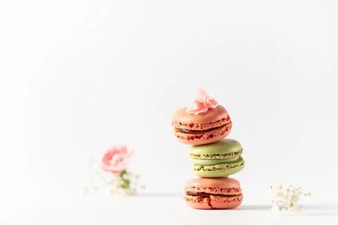 Different types of macaroons on a white background. Pink and green macaroons. Stock Photos