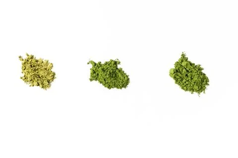 Different types of matcha green tea powder forming three heaps on white bac.. Stock Photos
