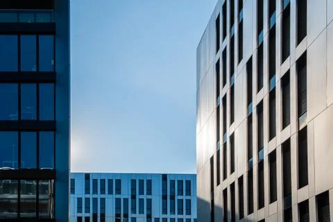 Different types of modern office building facades in front of blue evening sk Stock Photos