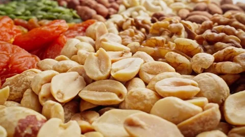 Different types of nuts. Assortment of various nuts and dried fruits rotating Video stock 304316304