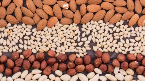 Different types of nuts in the form of stripes appear in the shot. Stop motion Stock Footage 72683970