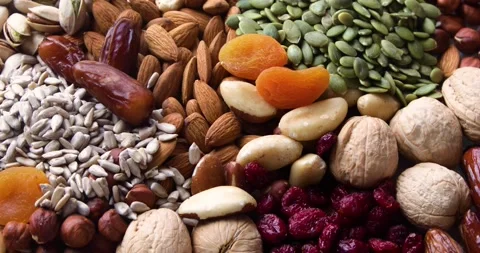 Different types of nuts, seeds and dried fruits	 Stock Footage 131955627