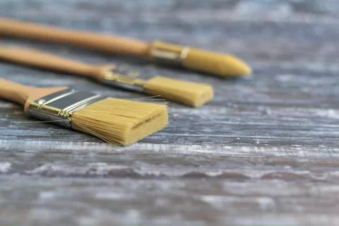 Different types of paint brushes on blue background Stock Photos