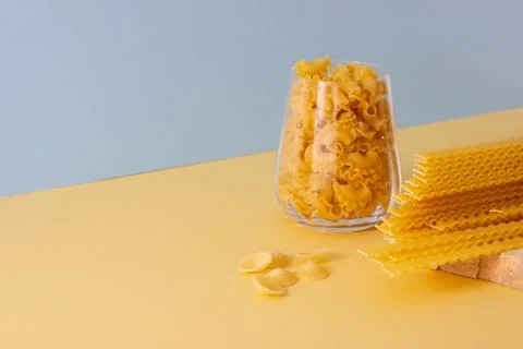 Different types of pasta, blue background. Stock Photos