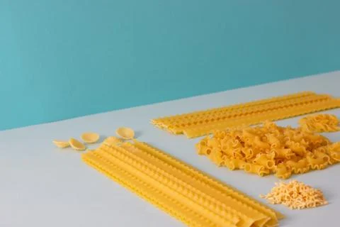 Different types of pasta, blue background. Stock Photos