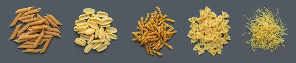 Different types of pasta on a dark gray background Stock Photos