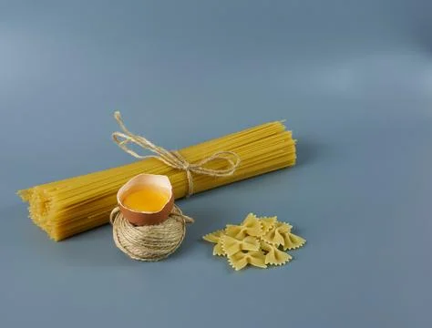 Different types of pasta on a gray background. Stock Photos