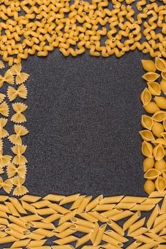 Different types of pasta on grey background. Cook background. Vertical frame Stock-Fotos