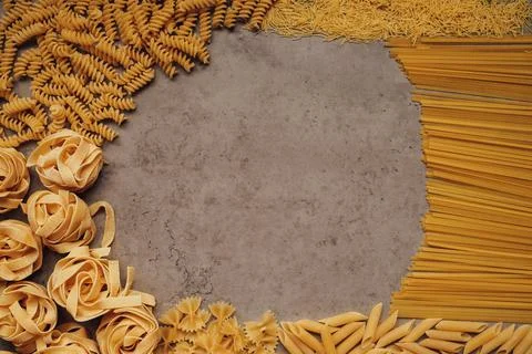 Different Types of Pasta Laid Up on the Table with Copy Space in the Middle Stock Photos