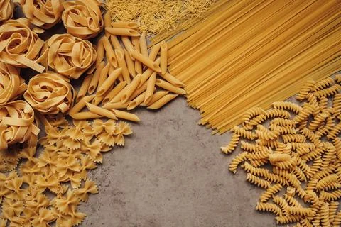 Different Types of Pasta Laid Up on the Table with Copy Space in the Bottom Stock Photos