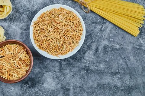 Different types of pasta on the marble background Stock Photos