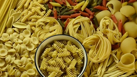 Different types of pasta rotate on the table Stock Footage 126246044